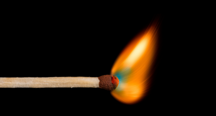 a lit match against black background