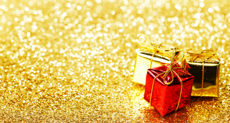presents wrapped in red and golden paper against glitter background