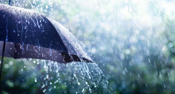 down pour of rain onto black umbrella