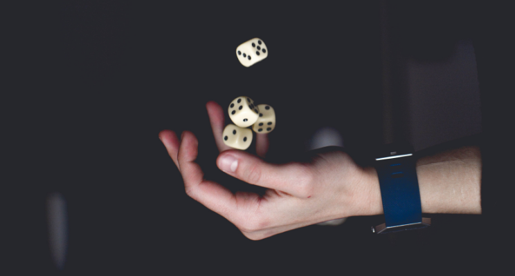 hand tossing dice into the air