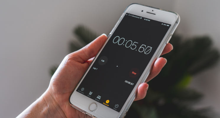 hand holding smartphone with timer function being used