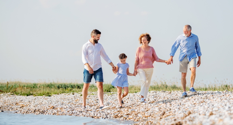 multi-generational family walking alongside the waterside